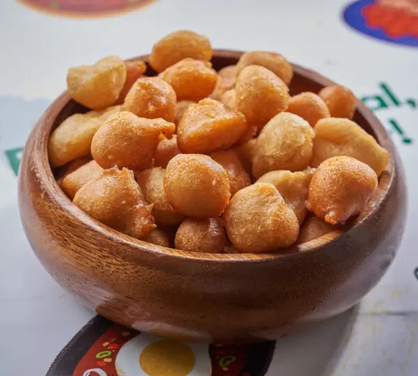 King Puff Puff served in a wooden bowl – popular Nigerian small chops street food.