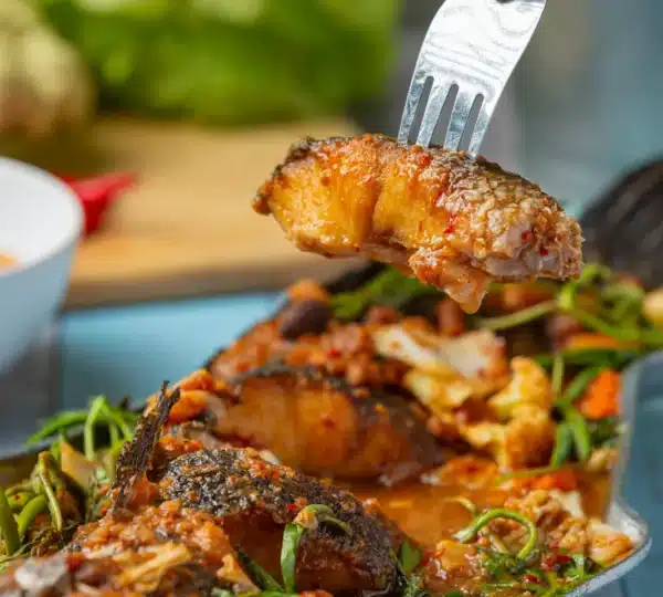 Grilled fish served with spicy sauce at a fine dining restaurant in Lagos Nigeria. 