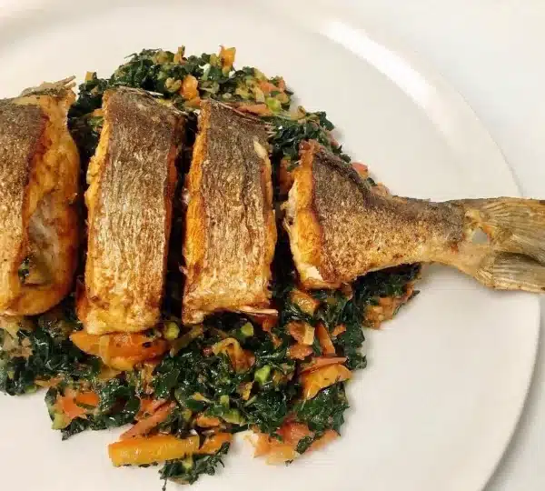 Efo Riro vegetable soup served with grilled fish — a healthy Nigerian food rich in vitamins A and C.