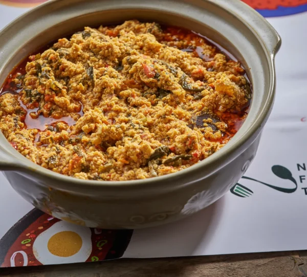 A close-up of rich, thick Egusi Soup made with ground melon seeds, vegetables, and palm oil — part of the classic Fufu and Egusi Soup combination enjoyed across Nigeria.
