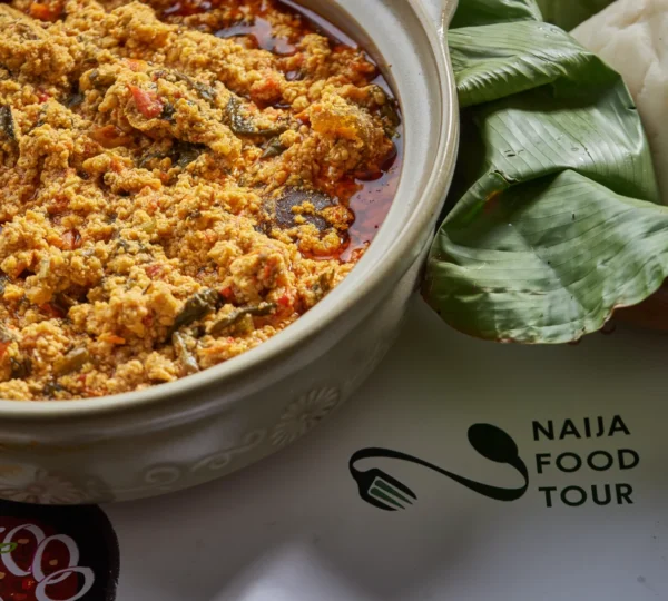 Fufu and Egusi Soup served in a bowl with tender meat — one of the most beloved Nigerian foods that define Lagos culture, known for its rich and hearty taste.