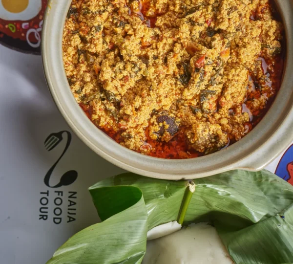 Egusi soup and fufu served on a Naija Food Tour mat, illustrating what culture fufu and egusi are from.