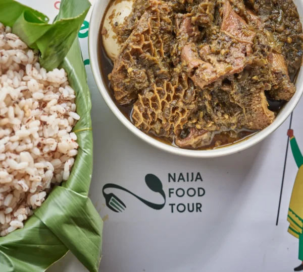 Ofada rice with ayamase stew made from green peppers and assorted meat — a flavorful Nigerian food that defines Lagos culture and local dining traditions.