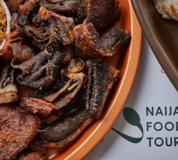 A close-up of sizzling Nigerian suya meat served during a Naija Food Tour — one of the most delicious fun things to do in Lagos for street food lovers.