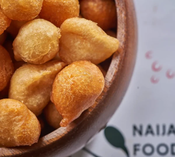 Golden-brown puff puff — sweet fried dough balls that capture the joy and simplicity of Nigerian street foods that define Lagos culture.