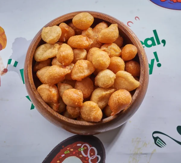 Bowl of puff-puff small chops enjoyed throughout Detty December in Lagos at weddings, concerts, and street events.