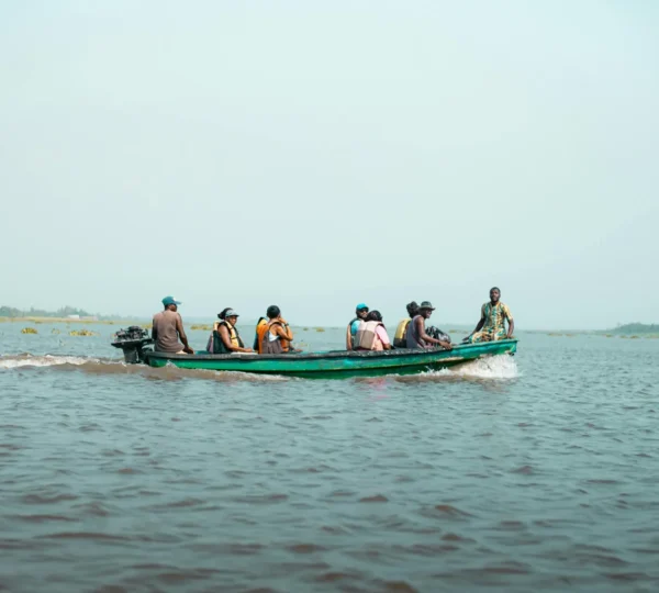 Tourists riding a boat across the Lagos Lagoon under a clear sky — a peaceful and scenic experience among fun things to do in Lagos. 