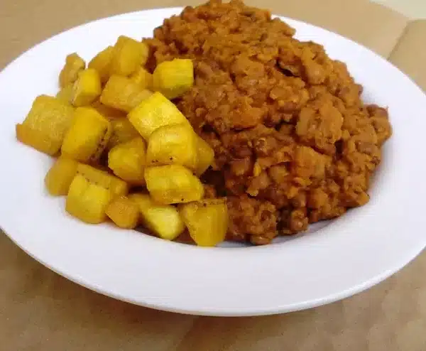 Beans and sweet potato pottage served with fried plantains — a high-protein healthy Nigerian food meal.